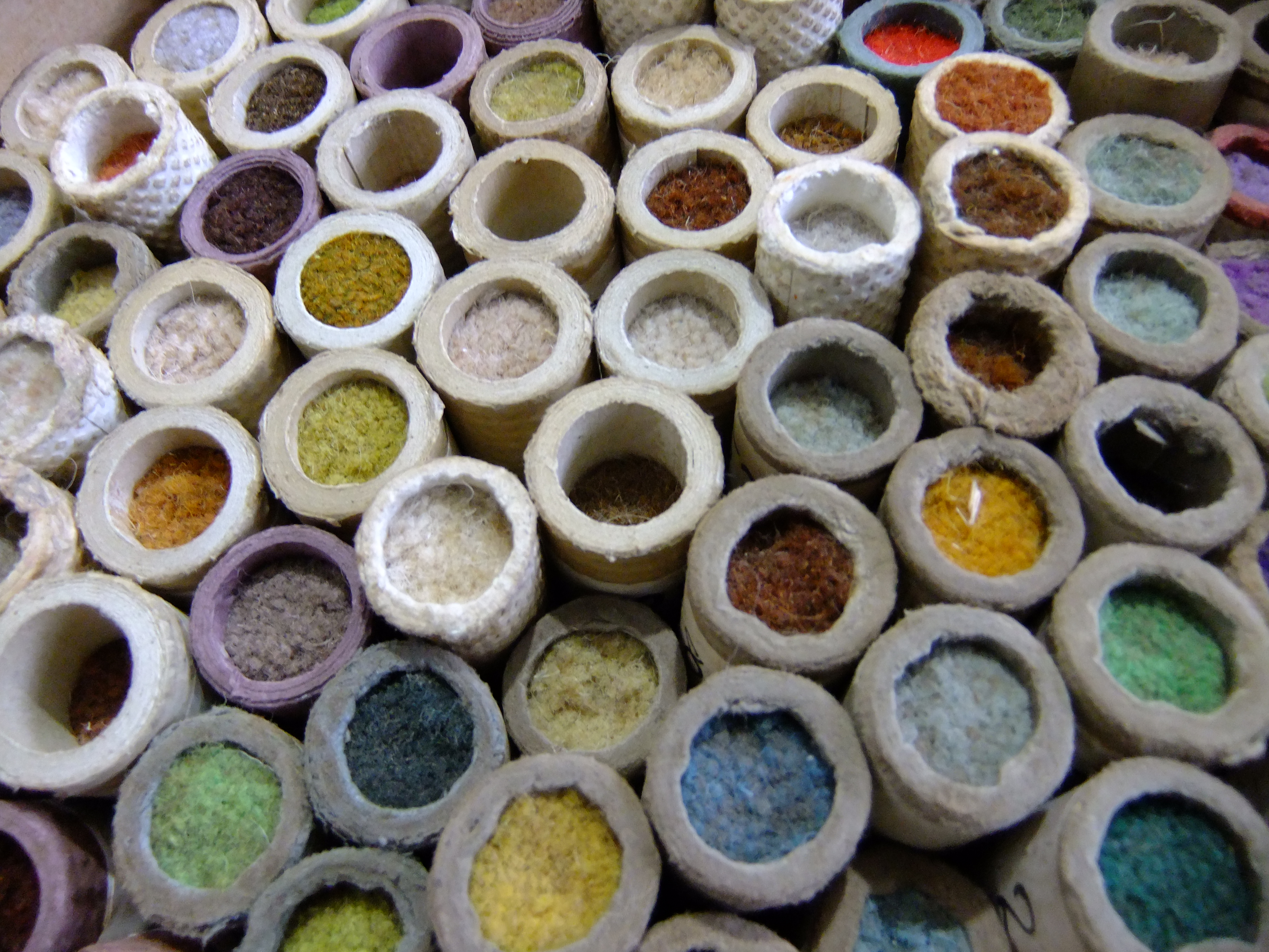 historical dye research - tubes of dyed wool samples for carpets